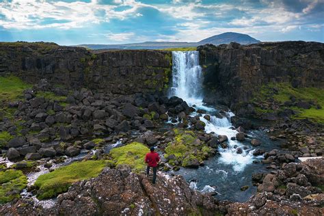 Tourist Looking At The Oxarafoss Waterfall In Iceland Photograph By
