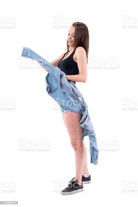 Relaxed Young Beautiful Brunette Woman Taking Off Jeans Jacket Stock
