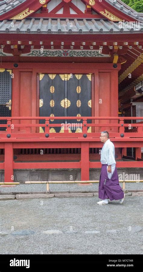 Colorfully Dressed Japanese Shinto Priest Walking In Front Of Beautiful