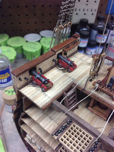 A Wooden Model Of A Boat With Tools On It
