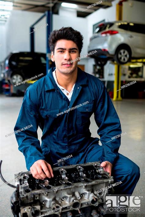 Mechanic Working On An Engine Stock Photo Picture And Royalty Free