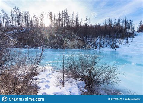 Turquoise Ice In The Frozen Bed Of The Irkut River In Early Spring