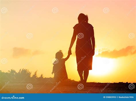 Mother And Little Daughter Walking At Sunset Stock Image Image Of