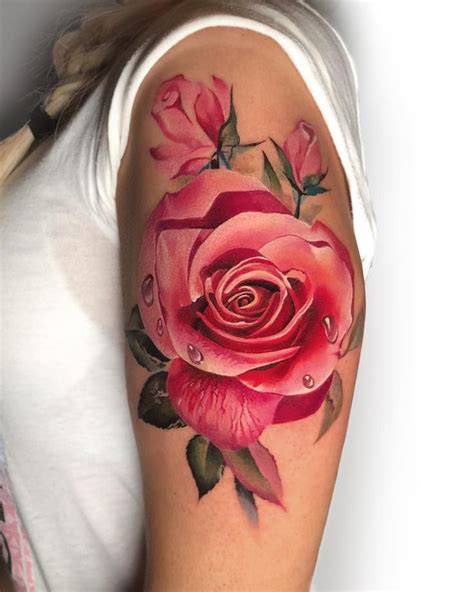A Woman With A Rose Tattoo On Her Arm