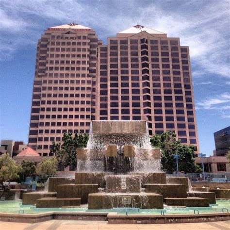 A Fountain In Front Of Two Tall Buildings