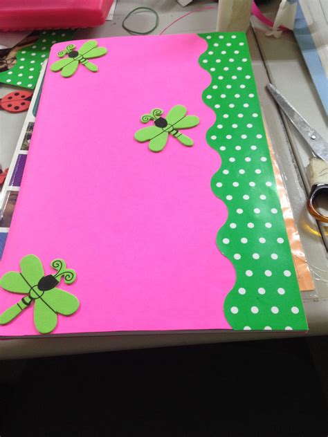 A Pink And Green Paper With Ladybugs On It Sitting Next To Scissors