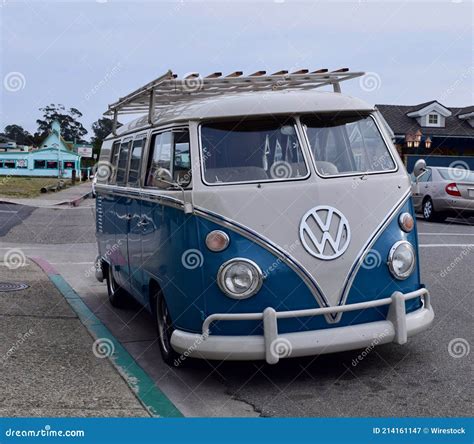 A Front View Of A Vintage Parked Blue And White Vw Bus With Rack At