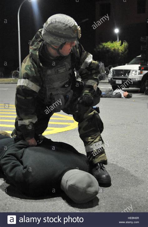 A Member Of The 51st Security Forces Squadron Restrains A Role Player