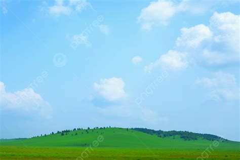 Green Grassland Under Blue Sky And White Clouds Background Blue Sky