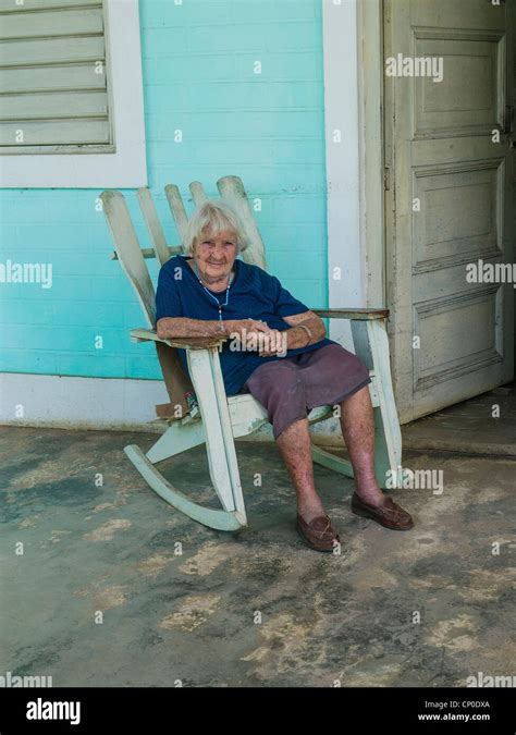 A 70 80 Year Old Cuban Hispanic Woman With Gray Hair Sits On Her
