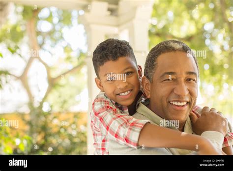African American Grandfather Hugging Grandson Hi Res Stock Photography