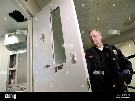 Yakima County Jail spokesman Cpl. Ken Rink shuts the door of the cell