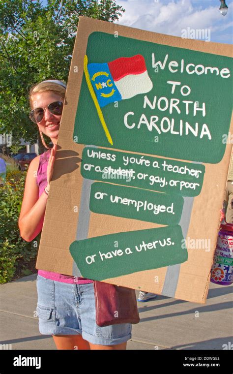 A Young Woman Holds A Sign About North Carolina Discrimination At A Moral Monday Protest Rally