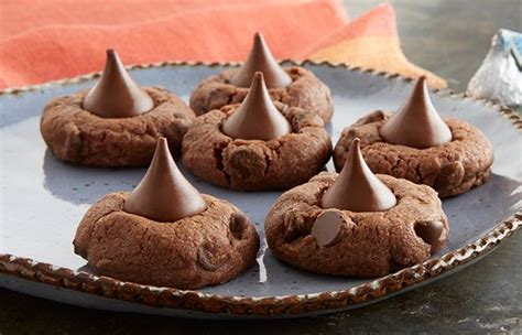 In a bowl, cream together the peanut butter and sugar until fluffy. KISSES Triple Chocolate Blossoms | Triple chocolate ...