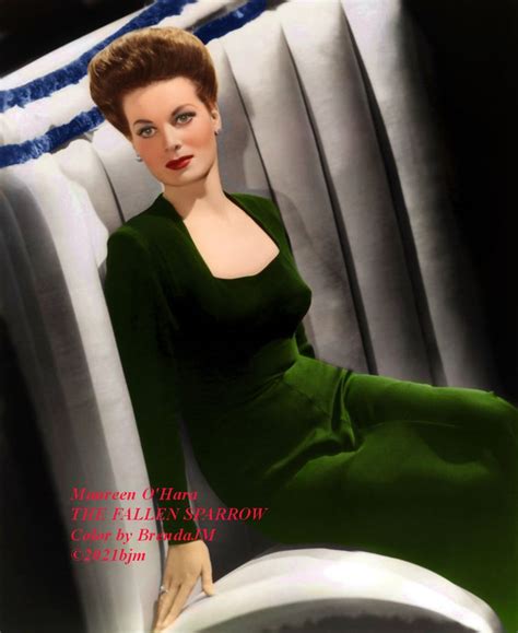 A Woman In A Green Dress Sitting On A Chair