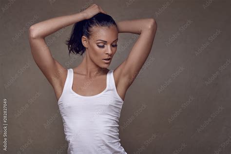 Sensual Beautiful Slim Middle Aged Woman In Summer Top Posing With One Hand To Her Chest And The