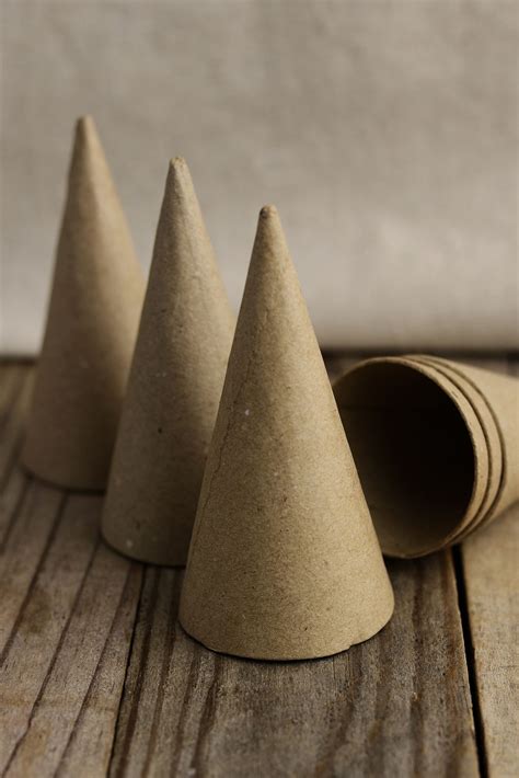 Three Small Cones Sitting On Top Of A Wooden Table