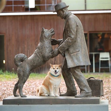 A Statue Of A Man With Two Dogs