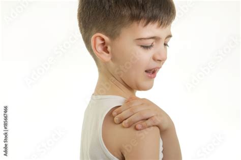 Shoulder Studio Shot Of Young Boy With Shoulder Pain Stock Photo