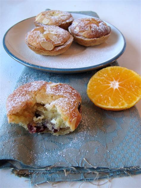 Two Plates With Pastries And An Orange Slice