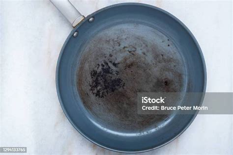A Ruined Non Stick Skillet On The Kitchen Counter Stock Photo