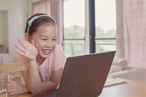 Mixed Race Young Asian Girl Making Facetime Video Calling With Laptop