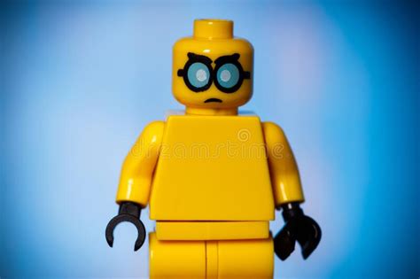Yellow Lego Figure With An Evil Face On A Blue Background With A