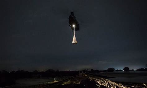 raf chinook helicopter works through the night to shore up defences in flood hit yorkshire