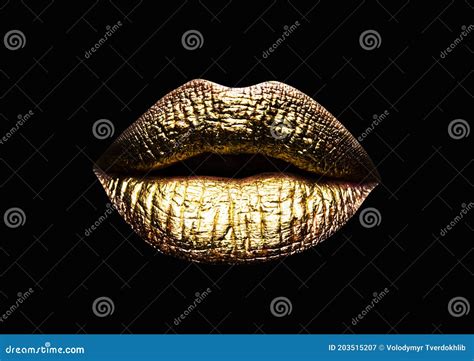gold lip closeup view of sexual beautiful female closed golden lips isolated on black