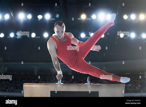 Male Gymnast Performing On Pommel Horse In Arena Stock Photo Alamy