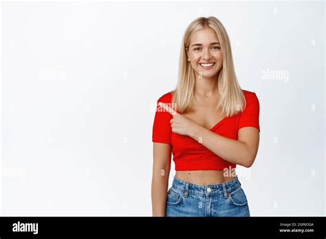 Smiling Happy Girl With Blond Hair And Tanned Skin Shows Advertisement