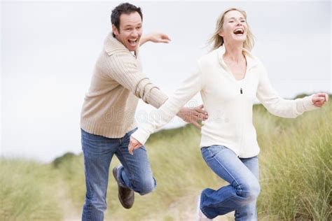 Couple Chasing One Another Through Dunes Stock Photo Image Of