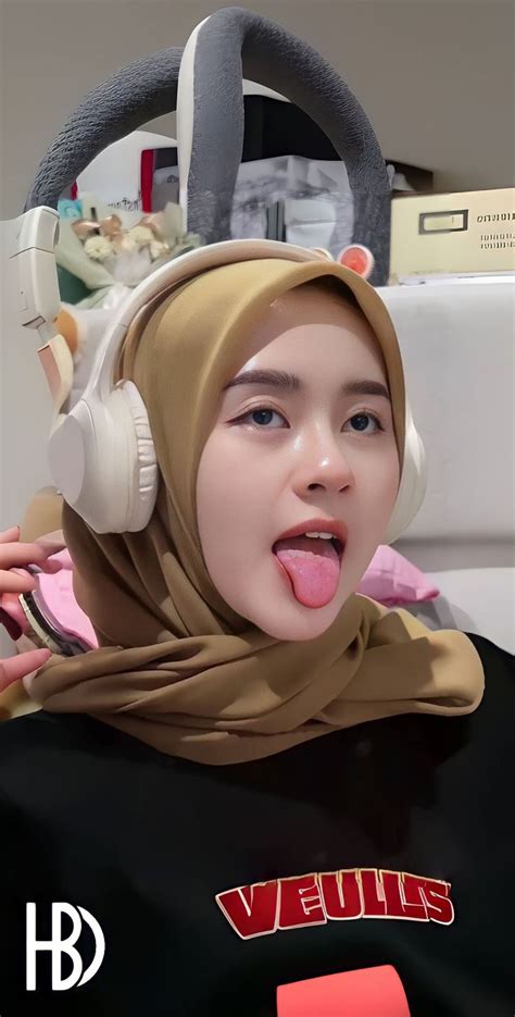 A Woman With Headphones Sticking Out Her Tongue