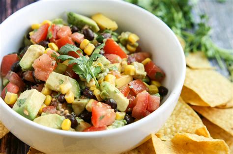 This avocado and mango salsa is a light and colorful party dish with chips. Mango Avocado Salsa