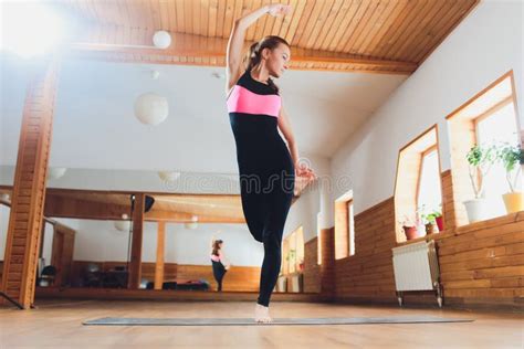 Portrait Of Sporty Beautiful Blond Young Woman In Sportswear Working Out Indoors Doing Balance
