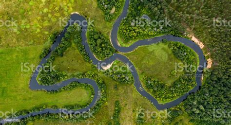 Top View Drone Shot Of A Green Field Forest And River Stock Photo