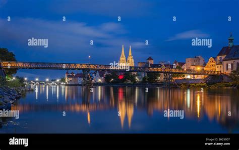 Old Town Regensburg Illuminated Cathedral And Stone Bridge To The Blue