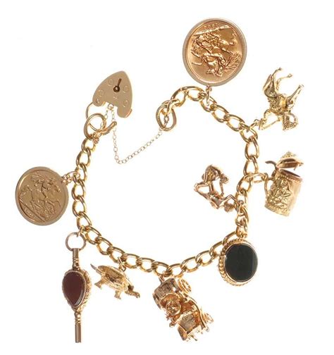 The gold anklet is yellow gold in color and has a high polished finish. 18CT GOLD CHARM BRACELET WITH 9CT GOLD AND 18CT GOLD CHARMS
