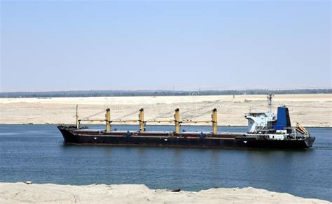 In this photo released by the suez canal authority, a boat navigates in front of a massive cargo ship, named the ever given, rear. Cargo Ship Transiting Through The Suez Canal. Stock Image - Image of view, trade: 158666899
