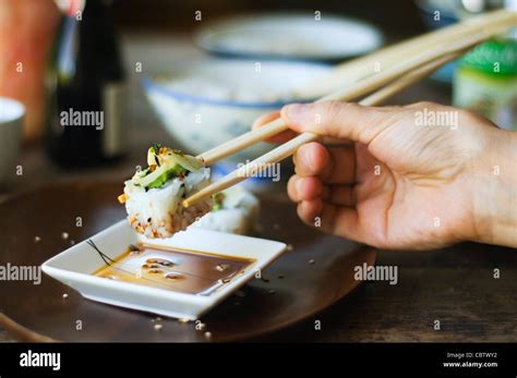 Person Eating Sushi With Chopsticks Stock Photo Alamy