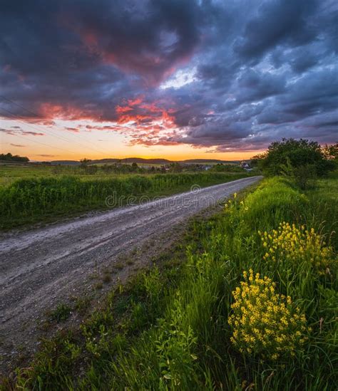 Gravel Countryside Road Through Spring Meadow Cloudy Evening Sunset