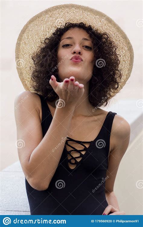 Girl With Curly Hair And Hat Blows A Kiss Stock Photo Image Of Architecture Look