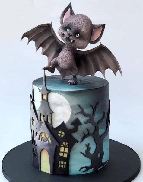 A Cake With A Bat On Top Of It And A Castle In The Back Ground