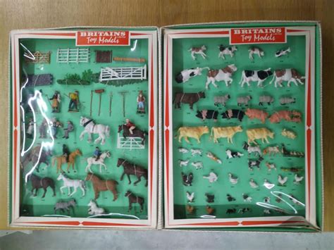 Two Open Boxes With Different Types Of Farm Animals On Them And In The