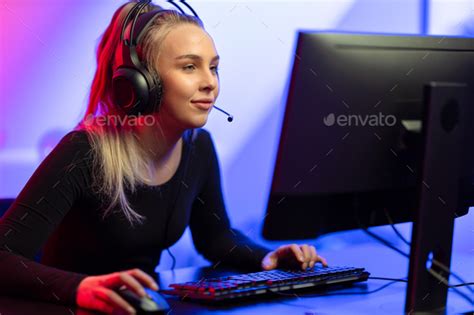 Focused E Sport Gamer Girl With Headset Playing Online Video Game On Pc
