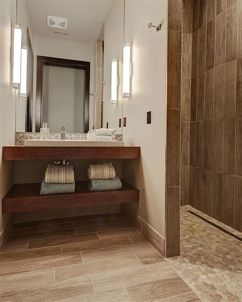 They learned the tile industry standards and methods for installing gauged. Pebbled stone shower floor pairs beautifully with large ...