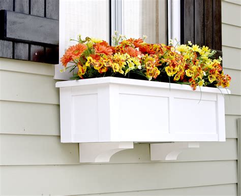 Next, line the bottom of the planter with landscaping cloth; Upgrade Window Boxes with Decorative Corbels