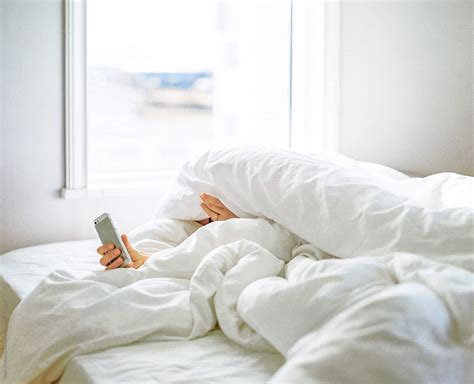 Person Under Blanket With Smart Phone By Duet Postscriptum