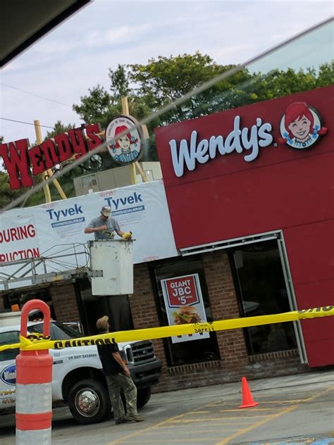 An old Wendy's sign next to a new one : r/mildlyinteresting