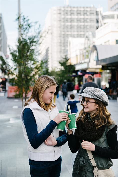 Teen Girls Enjoying A Smoothie Out Shopping In The City By Stocksy